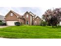 Charming two-story brick home with lush green front lawn, offering an inviting curb appeal at 7131 Topp Creek Ct, Indianapolis, IN 46214