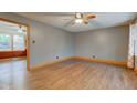 Spacious living room featuring hardwood floors, a ceiling fan, and bright, natural light at 7180 W Sacramento Dr, Greenfield, IN 46140