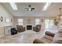 Bright living room features a fireplace, skylights, and an open floor plan at 7634 Pennycroft Dr, Indianapolis, IN 46236