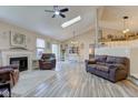Spacious living room boasts a fireplace, vaulted ceilings, and seamless flow to the dining area at 7634 Pennycroft Dr, Indianapolis, IN 46236