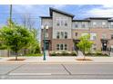 Charming townhouse complex with modern design and brick accents, enhanced by decorative street lighting in daytime at 8180 E 116Th St, Fishers, IN 46038