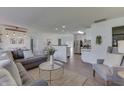 Bright and airy living room featuring a large gray sofa, a glass coffee table, and wood-look flooring at 91 Crestview Dr, Greenwood, IN 46143
