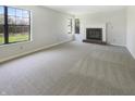 Bright and spacious living room featuring a fireplace, natural light, and neutral carpet at 9162 Hadway Dr, Indianapolis, IN 46256