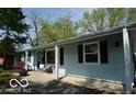 Charming ranch-style home featuring a light blue exterior and well-maintained landscaping at 10360 Wilson Rd, Brownsburg, IN 46112