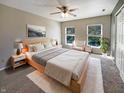 Bright bedroom featuring a ceiling fan, neutral walls, area rug, and two windows providing natural light at 10376 Alice Ct, Fishers, IN 46038