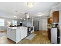 Bright kitchen with a large island, stainless steel appliances, and hardwood floors at 10421 Hillsdale Dr, Carmel, IN 46032