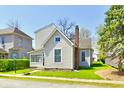 A cozy two-story home featuring a classic design with a well-kept lawn and mature trees at 106 S Wayburn St, Indianapolis, IN 46229