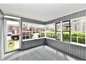 Bright sunroom with large windows offering ample natural light and views of the outdoors at 106 S Wayburn St, Indianapolis, IN 46229