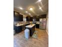 Modern kitchen with dark cabinets, stainless steel appliances, and granite countertops at 11726 Zander Dr, Indianapolis, IN 46235