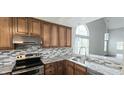 Modern kitchen showcasing granite countertops, stainless steel appliances, and ample cabinet space at 13648 Seven Oaks Dr, Fishers, IN 46038