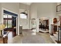 Grand foyer with soaring ceilings, tile flooring, and elegant staircase to the second floor at 13682 Frenchmans Creek, Carmel, IN 46032