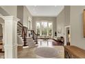 Bright living room featuring a fireplace, large windows, and hardwood floors at 13682 Frenchmans Creek, Carmel, IN 46032