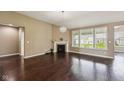 Spacious living room featuring hardwood floors, fireplace, and large windows at 14814 Edgebrook Dr, Fishers, IN 46040