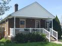 Lovely brick home showcasing a covered front porch, perfect for relaxing and enjoying the outdoors at 1640 Lawton Ave, Columbus, IN 47201