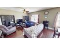 This large living area has dark hardwood floors, a ceiling fan, and plentiful natural light at 2441 Longleaf Dr, Greenwood, IN 46143