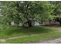 Traditional single-story home with a shaded front yard and a cozy front porch at 2508 N Routiers Ave, Indianapolis, IN 46219