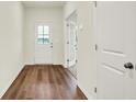 Inviting entryway with wood flooring, a front door, and white trim leading to the rest of the house at 2712 Glade Ave, Plainfield, IN 46168