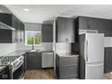 Modern kitchen with stainless steel appliances, sleek black cabinetry, and butcher block countertops at 2833 Hervey St, Indianapolis, IN 46203