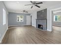 Spacious living room with a modern fireplace, ample natural light, and stylish ceiling fans at 2833 Hervey St, Indianapolis, IN 46203