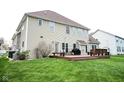Expansive backyard features a deck with seating, a grill, and a spacious green lawn at 3389 Grant Ct, Columbus, IN 47203