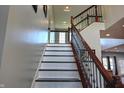 Elegant staircase features a wood railing, decorative metal spindles, and white risers at 3389 Grant Ct, Columbus, IN 47203