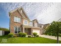 A well-kept lawn, brick facade, and two-car garage highlight this lovely home at 4622 Crosby Buck Dr, Indianapolis, IN 46237