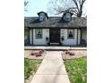 Home's front facade, showcasing a welcoming entrance, manicured landscaping, and attractive curb appeal at 4815 Carrollton Ave, Indianapolis, IN 46205
