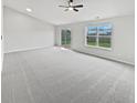 Bright, airy living room featuring neutral paint, soft carpet, and large windows for natural light at 491 Westview Dr, Bargersville, IN 46106