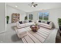 Spacious living room filled with sofas, a bookshelf, windows, and a modern rug at 491 Westview Dr, Bargersville, IN 46106