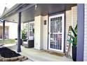 Cozy covered front porch with stylish seating, potted plants, and a welcoming entrance to the home at 5236 Skipping Stone Dr, Indianapolis, IN 46237