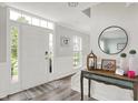 Bright entryway featuring a wood floor, decorative table, and plenty of natural light at 5595 Auburndale Dr, Bargersville, IN 46106