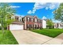 Charming home with a spacious driveway, manicured lawn, and an inviting facade at 5595 Auburndale Dr, Bargersville, IN 46106