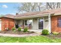 Inviting front porch with seating area, perfect for enjoying the outdoors, with mature landscaping at 5927 Pine Hill Dr, Indianapolis, IN 46235