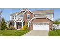 Beautiful two-story home with brick and gray siding, an attached two-car garage, and a well-maintained lawn at 6408 Askin Dr, Indianapolis, IN 46259