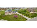 Sprawling brick house sits on a well-manicured lawn with a long driveway at 6519 Rothchild Blvd, Indianapolis, IN 46278