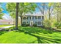 Beautifully landscaped two-story home with black shutters and a well-manicured lawn at 70 Williamsburg Ct, Zionsville, IN 46077