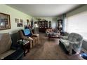 Bright living room with carpet, traditional furniture, and ample natural light at 712 E Mckenzie Rd, Greenfield, IN 46140