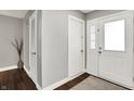 The entryway has gray walls, dark wood floors, white doors, and a decorative vase with branches at 731 Oak Dr, Greenwood, IN 46142