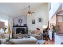 Stylish living room with a brick fireplace, vaulted ceilings, and plenty of natural light, perfect for relaxing or entertaining at 7594 W Williamswood Dr, New Palestine, IN 46163