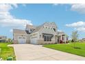 Wide driveway leads to this new home with three-car garage and verdant lawn at 8083 Easton Ln, Zionsville, IN 46077