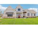 Beautiful new construction home with stone accents, covered porch and manicured lawn at 8083 Easton Ln, Zionsville, IN 46077