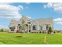Lovely new construction home with covered front porch and lush green lawn at 8083 Easton Ln, Zionsville, IN 46077