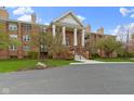 An eye-level front exterior shows the brick building's symmetrical design and manicured lawn at 8651 Jaffa Court East Dr # 18, Indianapolis, IN 46260