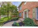 Inviting front entrance with brick facade, colorful wreath, manicured landscaping, and charming curb appeal at 933 Hummingbird Ln, Columbus, IN 47203