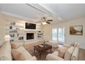 Bright living room with a fireplace, built-in bookshelves, and hardwood floors at 950 Nevelle Ln, Carmel, IN 46032