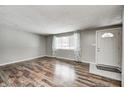 Inviting living room with beautiful flooring, a large window for natural light, and neutral paint at 9829 Chambray Dr, Indianapolis, IN 46280