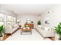 Bright living room featuring hardwood floors, two sofas, and decorative plants at 10362 Delphi Ct, Fishers, IN 46038