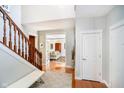 Bright foyer showcases the beautiful staircase and hardwood flooring and access to the living room at 10752 Tallow Wood Ln, Indianapolis, IN 46236