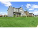 Beautiful two-story home in a Gathering-friendly neighborhood with a manicured lawn at 12902 Girvan Way, Fishers, IN 46037