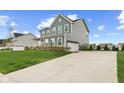 Two-story home with ample parking space and an attached two-car garage at 12902 Girvan Way, Fishers, IN 46037